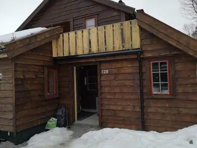 a house with a balcony on top of it at Cozy cabin centrally located in Hovden in Hovden