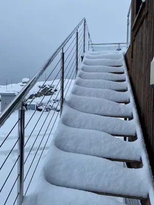a staircase covered in snow next to a building at Modern seaside holiday home in Bømlo