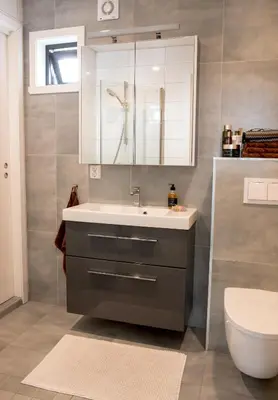 a bathroom with a sink and a toilet at Modern seaside holiday home in Bømlo