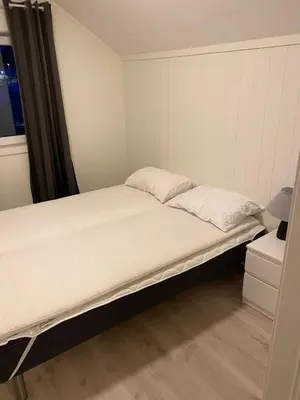 a large bed in a room with a window at Charming 2-bedroom loft by UNESCO site Jotunheimen and Vettifossen! in Årdalstangen