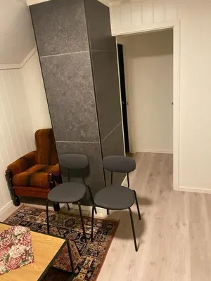 a living room with two chairs and a couch at Charming 2-bedroom loft by UNESCO site Jotunheimen and Vettifossen! in Årdalstangen