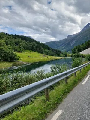 a river on the side of a road at timber cabin Eresfjord med båt til leie in Øverås