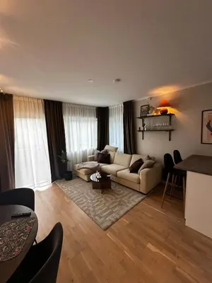 a living room with a couch and a table at Cozy and central apartment in Tyholt in Trondheim