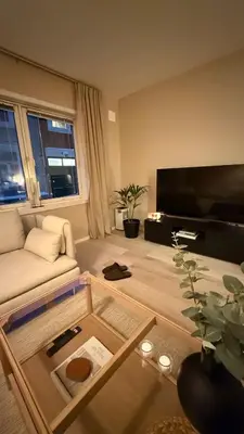 a living room with a couch and a table at Delicate Central Apartment Trondheim in Trondheim
