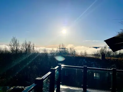 a view of the sun rising over a field at New modern cabin in Beitostølen in Beitostøl