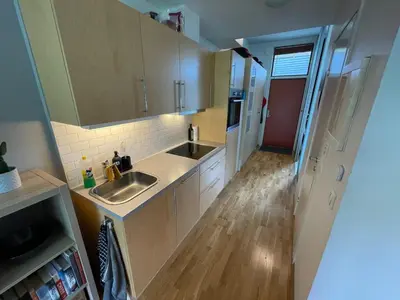 a kitchen with a sink and a counter top at Cozy 1-bedroom in quiet Ilsvika in Trondheim