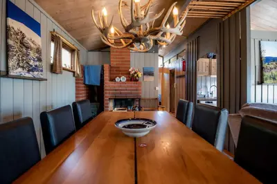 a dining room with a wooden table and chairs at Trysilfjellet Sør 17 in Trysil