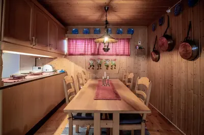 a dining room with a wooden table and chairs at Trysilfjellet Nord 607 in Trysil