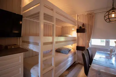 a bunk bed in a small room with a desk and a bed at Trysilfjellet Nord 1071B in Trysil
