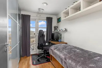 a bedroom with a bed and a desk with a computer at House with 5 bedrooms very close to World Cup 25 in Granåsen in Trondheim