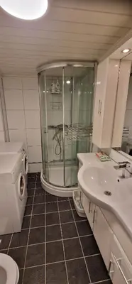 a bathroom with a shower and a sink and a toilet at Storgata 36B in Lillehammer