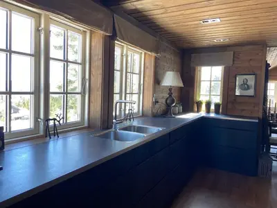 a kitchen with a sink and some windows at Wonderful Ski-In, ski-out Cabin at Kvitfjell in Strande