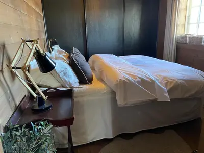 a bedroom with a bed and a table with a lamp at Wonderful Ski-In, ski-out Cabin at Kvitfjell in Strande