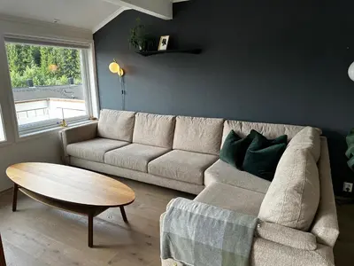a living room with a couch and a table at Granåsen ski-VM in Trondheim