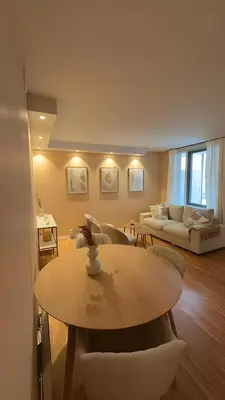 a living room with a table and a couch at Modern and chic city apartment - Bergen City in Bergen
