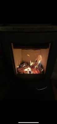 a fire inside of a oven with flames in it at Beautiful and central apartment for rent during Ski WC 2025 in Trondheim