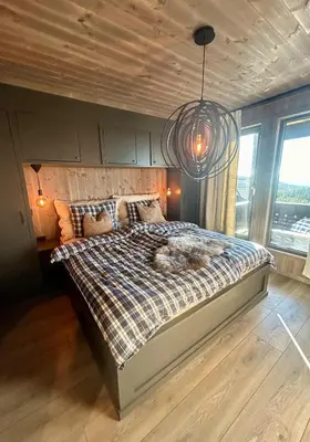 a bedroom with a large bed in a room at Norefjell! Newly built cabin with stunning view in Noresund