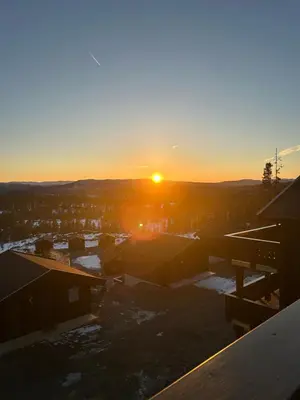 a sunset from the roof of a building at Norefjell! Newly built cabin with stunning view in Noresund