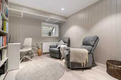 a living room with two chairs and a couch at Spacious and Peaceful Home with a Private Gym in Trondheim