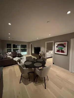 a living room with a table and chairs and a couch at Modern Appartement - Ski World Cup 2025 in Trondheim