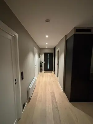 an empty hallway of a house with wooden floors at Modern Appartement - Ski World Cup 2025 in Trondheim