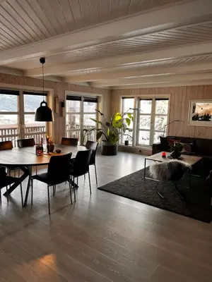 a living room with a table and chairs at Fairy tale house during Ski world cup in Melhus