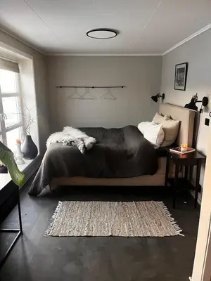 a bedroom with a bed and a rug in it at Fairy tale house during Ski world cup in Melhus