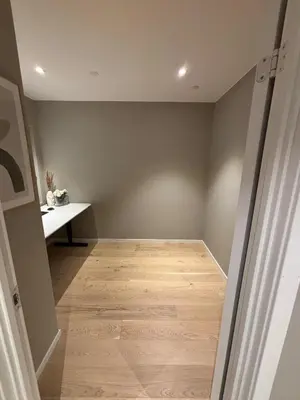 an empty room with a table and a wooden floor at Modern Appartement - Ski World Cup 2025 in Trondheim
