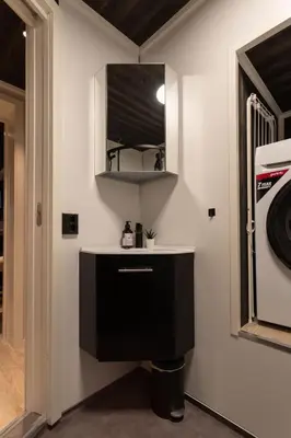 a kitchen with a sink and a microwave at Studio Plassen in Sogndal