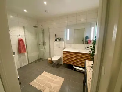a bathroom with a tub and a toilet and a sink at Hus til leie under VM 2025 in Trondheim