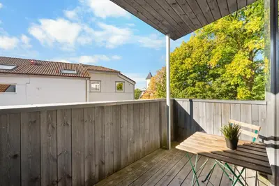 a balcony with a wooden fence and a wooden bench at Architectural Studio I Private Balcony in Bergen