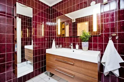 a red tiled bathroom with a sink and a mirror at World championship ski 2025-Cozy house for rent in Trondheim