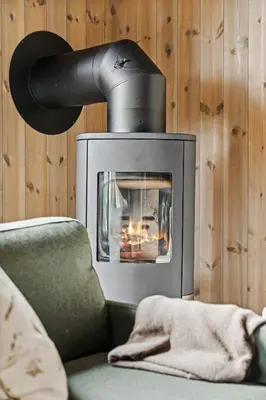 a living room with a fireplace and a couch at Very central and fresh apartment 4 bedr, 10p 2 floors, sauna, ski in and out in Trysil