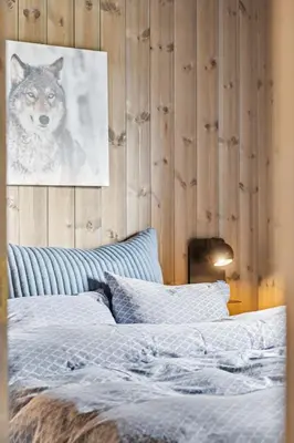 a bedroom with a wolf picture on the wall at Very central and fresh apartment 4 bedr, 10p 2 floors, sauna, ski in and out in Trysil