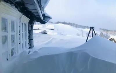 a pile of snow on the side of a house at Stunninng Home In Rauland With Sauna in Rauland