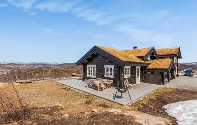 a small house with a grass roof on a deck at Stunninng Home In Rauland With Sauna in Rauland