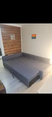 a bed in the corner of a room at Koselig leilighet på Møllenberg in Trondheim