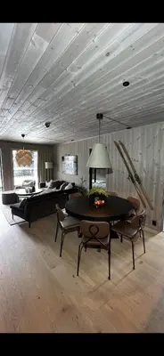 a living room with a table and a bed at Hemsedal, sengeplass til 8, ski inn ski out in Hemsedal