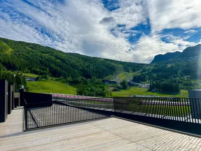a balcony with a view of a mountain at Hemsedal, sengeplass til 8, ski inn ski out in Hemsedal