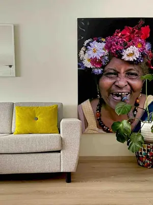 an older woman with flowers on her head in a painting at Townhouse in quiet and central area with free parking in Trondheim