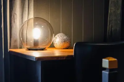 a glass ball on a wooden table with two eggs at Bergmannshuset in Løkken