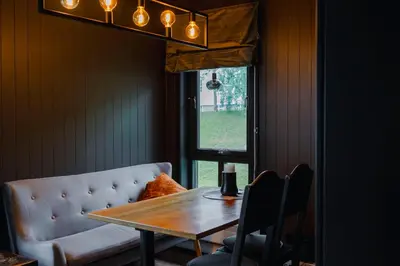 a dining room with a table and a couch at Bergmannshuset in Løkken