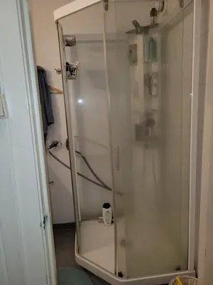 a shower with a glass door in a bathroom at 4 and 6 bedroom apartments Ski WC in Trondheim
