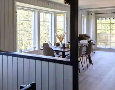 a dining room with tables and chairs and windows at ThePearl in Sel