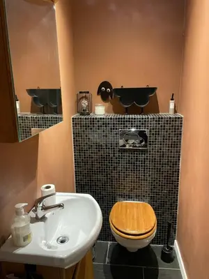 a bathroom with a toilet and a sink at 2 etasjers leilighet in Trondheim