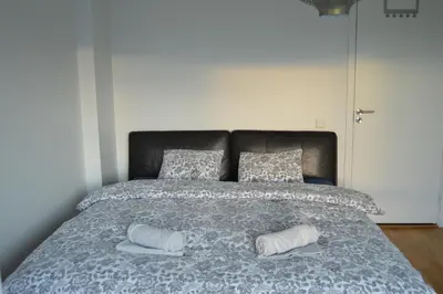a bedroom with a bed with two pillows on it at Modern 3-story house by the sea & public transport in Trondheim