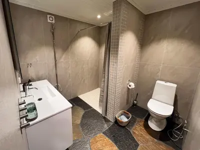 a bathroom with a toilet and a shower and a sink at TheHideaway in Sel