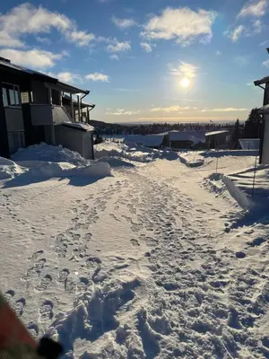a snow covered street with footprints in the snow at Apartment Sjusjøen in Sjusjøen