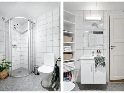 a white bathroom with a shower and a toilet at Stilfull sentrumsnær leilighet in Bergen