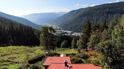 a red roofed house with a view of a valley at FourGotten in Sel